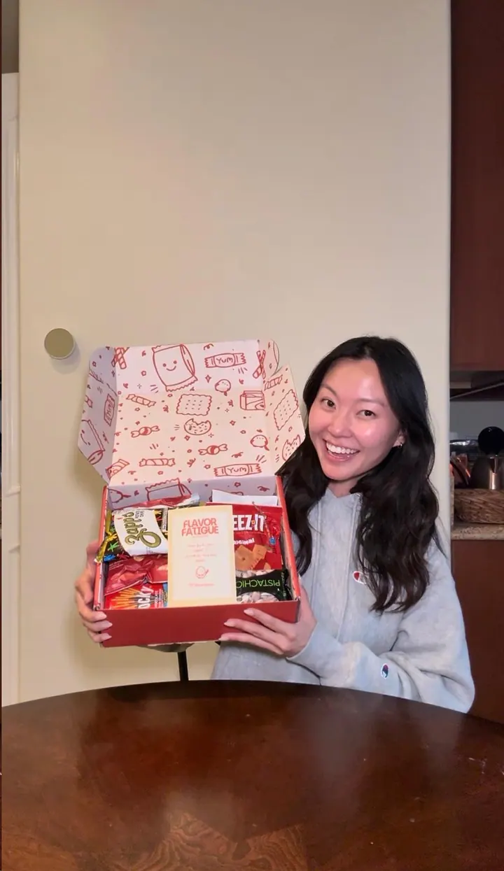 Melanie holding an open snack box